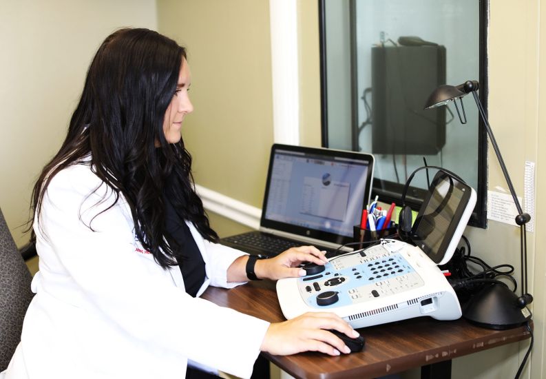 Allison Mckeon performing a hearing test to determine if hearing aids are needed